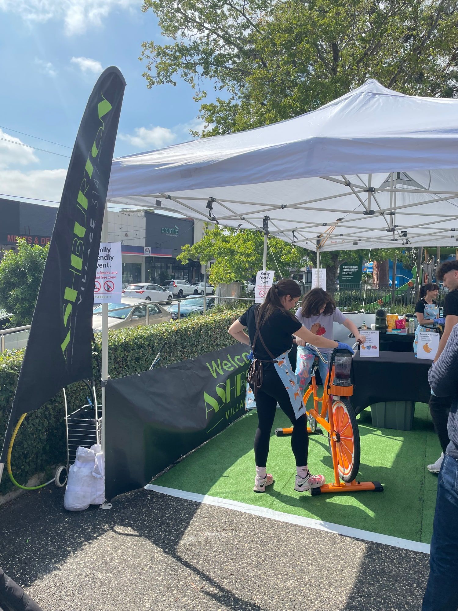 The Smoothie Bikes marquee and orange bike set up at a precinct event