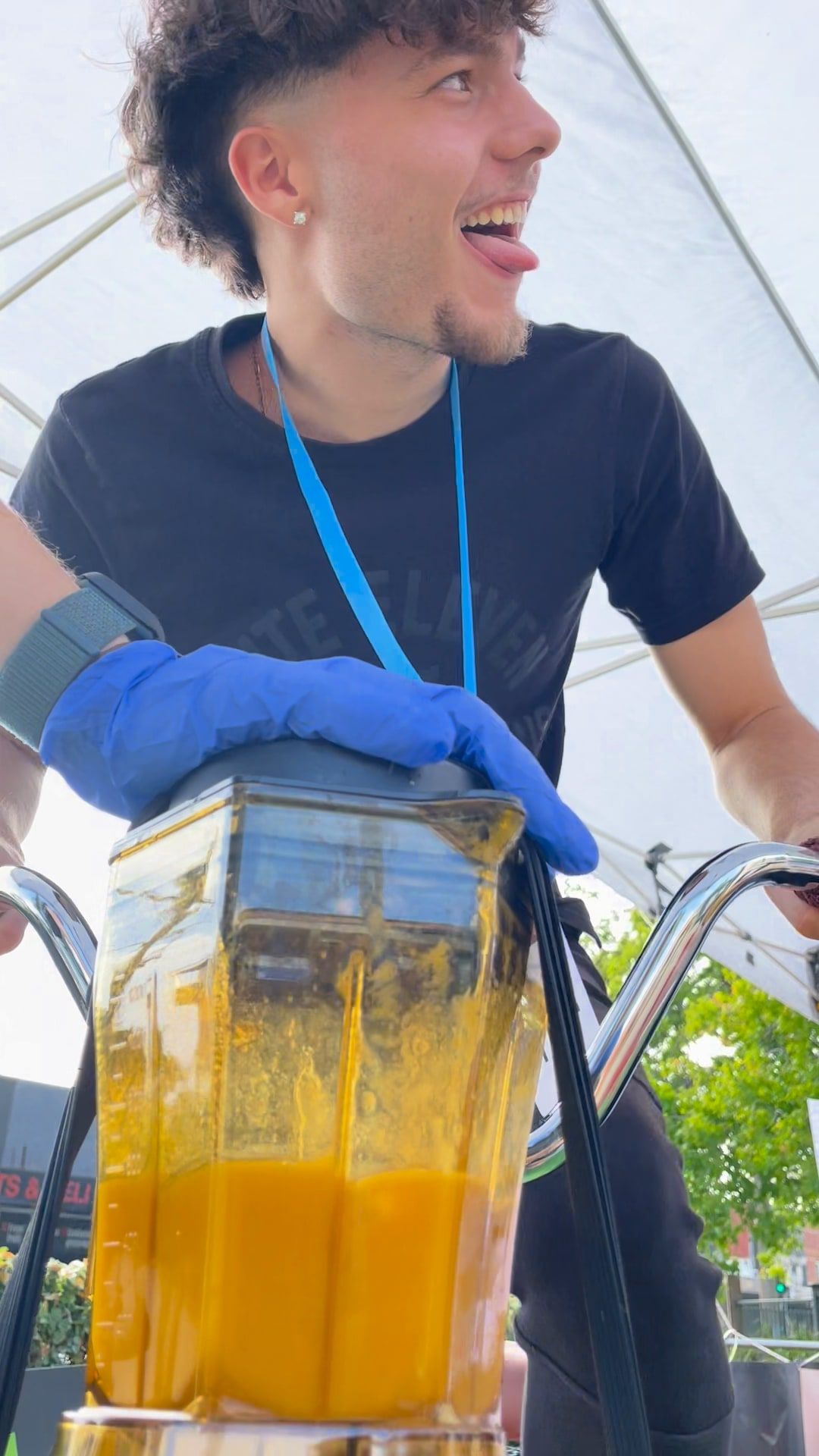 A staff member has fun with a jug of mango smoothie